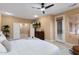 Comfortable bedroom with neutral tones, ceiling fan, and access to an outdoor space at 19814 N Shadow Mountain Dr, Surprise, AZ 85374