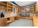 Well-lit office featuring custom built-in shelving, cabinetry and a window seat at 19814 N Shadow Mountain Dr, Surprise, AZ 85374
