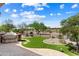 View of the backyard landscaping, barbecue, and patio at 26822 W Oraibi Dr, Buckeye, AZ 85396