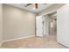Bedroom featuring neutral walls, tile floors, and double doors leading to additional living space at 26822 W Oraibi Dr, Buckeye, AZ 85396