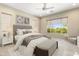 Cozy bedroom with neutral tones, soft lighting, and a large window at 26822 W Oraibi Dr, Buckeye, AZ 85396