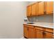 Butler pantry with sink, ample countertop space, and wood cabinets at 26822 W Oraibi Dr, Buckeye, AZ 85396