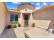 Private courtyard showcasing a seating area, potted plants, and a stylish, inviting entry at 26822 W Oraibi Dr, Buckeye, AZ 85396