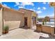 Paver patio, side entrance door, and access to the garage creating an inviting outdoor space at 26822 W Oraibi Dr, Buckeye, AZ 85396