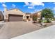A single-story house showcases a two-car garage, desert landscaping, and well-maintained surroundings at 26822 W Oraibi Dr, Buckeye, AZ 85396