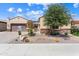 Inviting single-story home with a two-car garage, desert landscaping, and stone accents at 26822 W Oraibi Dr, Buckeye, AZ 85396