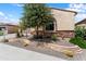 A single-story home features desert landscaping, rock accents, and a charming, well-kept front yard at 26822 W Oraibi Dr, Buckeye, AZ 85396