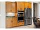 Kitchen featuring stainless steel appliances, wood cabinets, and granite countertops at 26822 W Oraibi Dr, Buckeye, AZ 85396
