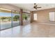 Expansive living room with slider to patio, windows, tile floors, and neutral walls at 26822 W Oraibi Dr, Buckeye, AZ 85396