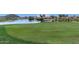 Green golf course with pond and residential homes in background at 298 E Diamond Trl, San Tan Valley, AZ 85143