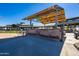Covered outdoor bar area with seating and a grill at 298 E Diamond Trl, San Tan Valley, AZ 85143