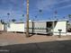 Mobile home exterior with covered patio and desert landscaping at 4065 E University Dr # 140, Mesa, AZ 85205