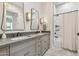 Modern bathroom with double vanity, gray cabinets, and a shower/tub combo at 4424 N 38Th St, Phoenix, AZ 85018