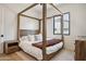 Primary bedroom with a wooden canopy bed and natural light at 4424 N 38Th St, Phoenix, AZ 85018