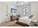 Bright bedroom with wood flooring, a queen bed, and built-in dresser at 4424 N 38Th St, Phoenix, AZ 85018