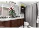 Bathroom with double vanity and gray shower curtain at 8813 N 112Th Ave, Peoria, AZ 85345