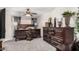 Spacious bedroom with dark wood furniture and carpeted floors at 8813 N 112Th Ave, Peoria, AZ 85345