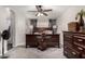 Bedroom with dark wood furniture and ceiling fan at 8813 N 112Th Ave, Peoria, AZ 85345