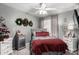 Guest bedroom with gray upholstered bed and red bedding at 8813 N 112Th Ave, Peoria, AZ 85345