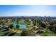 Breathtaking aerial view of a golf course with ponds, trees, and a city skyline in the background at 914 E Osborn Rd # 202, Phoenix, AZ 85014