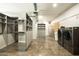 Walk-in closet with shelving, drawers, washer and dryer providing ample storage at 914 E Osborn Rd # 202, Phoenix, AZ 85014