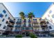 Building entrance with palm trees and pool at 914 E Osborn Rd # 202, Phoenix, AZ 85014
