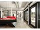 Spacious game room featuring a pool table, bar area and doors to the outside patio at 914 E Osborn Rd # 202, Phoenix, AZ 85014