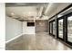 Bright living room with brick accent wall, TV and many doors to the outside at 914 E Osborn Rd # 202, Phoenix, AZ 85014