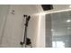 Modern shower featuring gray tiled wall with matte black shower head and hardware at 914 E Osborn Rd # 202, Phoenix, AZ 85014