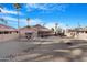 The backyard includes a water feature, desert landscaping and palm trees at 10309 E Twilight Ct, Sun Lakes, AZ 85248