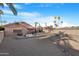 The backyard includes a water feature, desert landscaping and palm trees at 10309 E Twilight Ct, Sun Lakes, AZ 85248