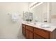Well lit bathroom features a wood vanity and an expansive mirror at 10309 E Twilight Ct, Sun Lakes, AZ 85248