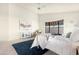 Inviting bedroom with light tones, a plush rug, and a cozy chair by a sunlit window at 10309 E Twilight Ct, Sun Lakes, AZ 85248