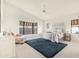 Bright bedroom features a vaulted ceiling, bay window, and a comfortable sitting area at 10309 E Twilight Ct, Sun Lakes, AZ 85248