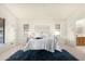 A well-lit bedroom with a plush rug and views into the ensuite bathroom at 10309 E Twilight Ct, Sun Lakes, AZ 85248