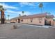 Rear exterior showing the desert landscaping, awning-shaded windows, and tiled roof at 10309 E Twilight Ct, Sun Lakes, AZ 85248