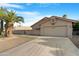 Exterior view featuring desert landscaping, tiled roof, and two car garage at 10309 E Twilight Ct, Sun Lakes, AZ 85248