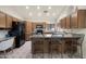 Kitchen boasts granite countertops, a breakfast bar, and wood cabinetry at 10309 E Twilight Ct, Sun Lakes, AZ 85248