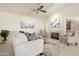 Comfortable living room boasting vaulted ceiling, neutral tones, plush seating, and fireplace at 10309 E Twilight Ct, Sun Lakes, AZ 85248