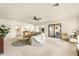 The living room is spacious and bright, featuring neutral carpeting and an open floor plan at 10309 E Twilight Ct, Sun Lakes, AZ 85248