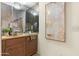 Close-up of wet bar with wooden cabinets and a mirrored backsplash at 10309 E Twilight Ct, Sun Lakes, AZ 85248