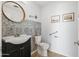 Charming powder room with a modern vanity, tile accents, and a stylish round mirror at 17 W Vernon Ave # 316, Phoenix, AZ 85003
