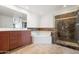 A luxurious bathroom featuring a large vanity, soaking tub, and glass-enclosed shower at 17 W Vernon Ave # 316, Phoenix, AZ 85003