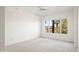 A bright and airy bedroom with neutral carpet and a large window with views of palm trees at 17 W Vernon Ave # 316, Phoenix, AZ 85003