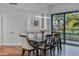 Bright dining room with modern lighting, wood floors, and a sliding glass door to the balcony at 17 W Vernon Ave # 316, Phoenix, AZ 85003