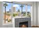 Close-up of the fireplace with decorative tile and views of the city skyline at 17 W Vernon Ave # 316, Phoenix, AZ 85003