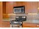 Modern kitchen features stainless steel appliances and granite countertops at 17 W Vernon Ave # 316, Phoenix, AZ 85003