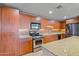 Modern kitchen with wood cabinets and granite counters at 17 W Vernon Ave # 316, Phoenix, AZ 85003