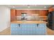 Modern kitchen features stainless steel appliances and a large center island at 17 W Vernon Ave # 316, Phoenix, AZ 85003