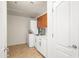 Bright laundry room with a stackable washer and dryer, storage cabinets, and a utility sink at 17 W Vernon Ave # 316, Phoenix, AZ 85003